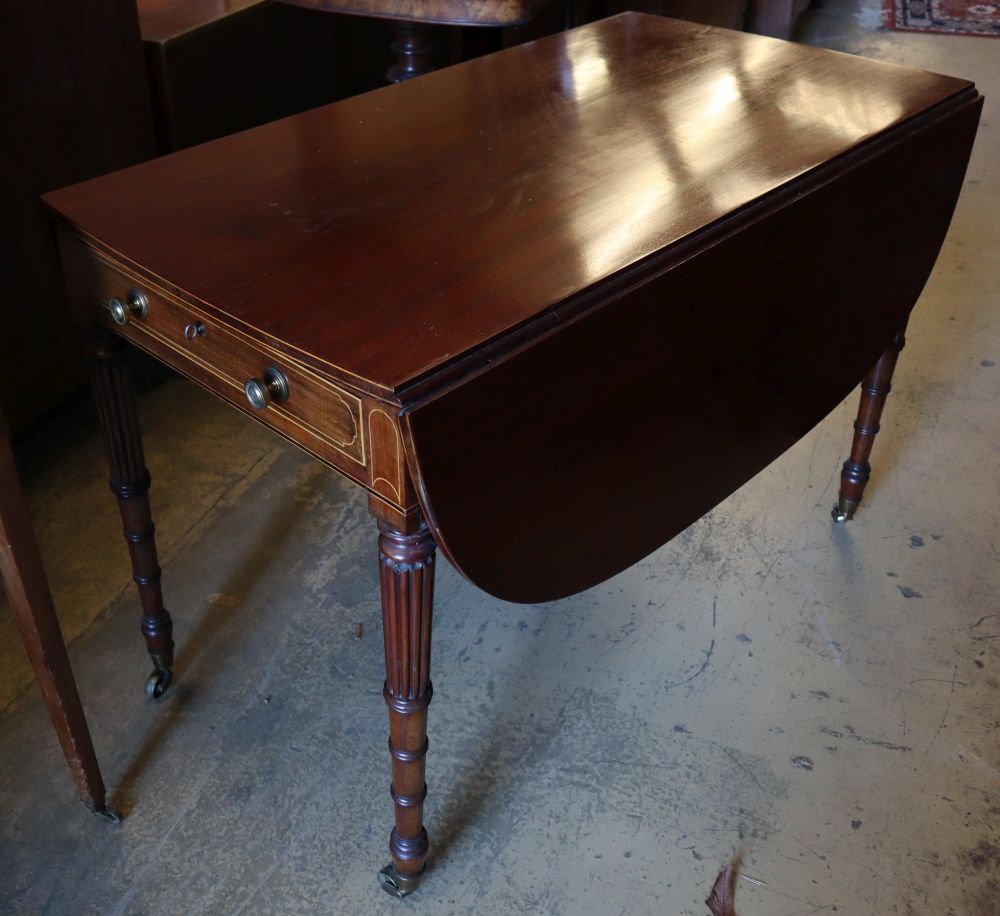 A Regency mahogany sofa table, with D shaped flats and frieze drawer on turned and fluted tapered legs, fitted brass castors, width 102